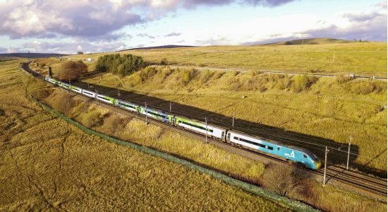 A train travelling through green countryside.